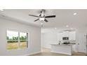 Bright living area with large windows overlooking lush greenery and an open floor plan at 7008 Jerimoth Dr, Charlotte, NC 28215