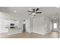 Bright, open-concept living space features hardwood floors, neutral walls, and a modern ceiling fan at 7008 Jerimoth Dr, Charlotte, NC 28215