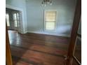 Sunlit living room with hardwood floors and classic windows bringing the outdoors in at 716 N Fulton St, Salisbury, NC 28144