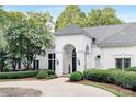 Beautifully landscaped front exterior with stone accents and brick facade at 7912 Baltusrol Ln, Charlotte, NC 28210