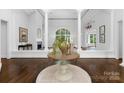 Inviting foyer with hardwood floors and a grand window, flooded with natural light at 7912 Baltusrol Ln, Charlotte, NC 28210