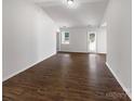 Spacious living area with hardwood floors, a back door, and bright natural light at 8219 Pozzi Rd, Charlotte, NC 28216