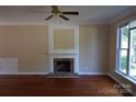 Bright living room featuring hardwood floors and a fireplace at 9228 Old Barnette Pl, Huntersville, NC 28078
