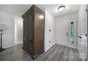 Spacious foyer with sleek wood laminate flooring and a decorative armoire, adjacent to the front door at 1003 Cranberry Cir, Fort Mill, SC 29715