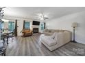 Cozy living room with stylish flooring, a fireplace, and large windows providing natural light and a view at 1003 Cranberry Cir, Fort Mill, SC 29715
