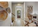 Bright foyer features wood floors, Gathering decor, arched entry, and a view of the front door leading to the landscaped yard at 1009 Hercules Dr, Indian Trail, NC 28079