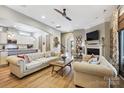 Open concept living room features wood floors, fireplace, TV, sofas, leading to kitchen, dining area and entry hall at 1009 Hercules Dr, Indian Trail, NC 28079