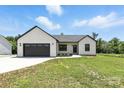 Well-maintained home with an attached garage, surrounded by lush green grass at 1019 Null Rd, Lincolnton, NC 28092