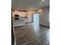 A bright living room features wood floors, modern lighting, and sliding glass doors to enhance natural light at 1022 Jeffery Dean Ct, Albemarle, NC 28001