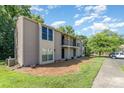 This exterior shows the side of a condo with a well-maintained lawn and features a parking space for residents at 11049 Cedar View Rd, Charlotte, NC 28226