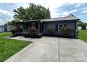 Charming home featuring a well-manicured lawn, covered porch, and landscaping at 111 Rose St, Mount Holly, NC 28120
