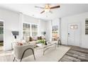 Inviting living room with natural light, neutral colors, plush seating, and a ceiling fan at 1117 Thayer Glen Ct, Charlotte, NC 28213