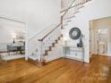 Elegant foyer with hardwood floors, a staircase, and tasteful decor at 1140 Iverleigh Trl, Charlotte, NC 28270