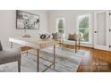 Bright home office featuring a modern desk and large windows at 1140 Iverleigh Trl, Charlotte, NC 28270