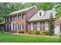 Lovely two-story brick home with blue shutters, green grass, and manicured landscaping at 1545 Chadmore Nw Ln, Concord, NC 28027