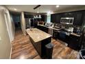 A well-equipped kitchen featuring dark cabinets, granite countertops, and stainless steel appliances at 2116 Dana Pl, Shelby, NC 28152