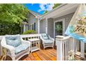 Inviting front porch with white wicker chairs and a cozy seating area, adding curb appeal to the home at 2490 Hawk Ridge Dr, Gastonia, NC 28056