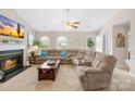 Bright and airy living room with a fireplace, plush sectional sofa, and large windows at 2490 Hawk Ridge Dr, Gastonia, NC 28056