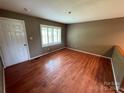 Spacious living room featuring hardwood floors, neutral walls, and a bright window at 2547 Nc 182 Hwy, Lincolnton, NC 28092
