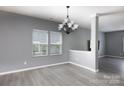 Bright dining area features gray walls, modern chandelier, and ample natural light from large windows at 2720 Watergarden St, York, SC 29745