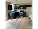 A modern kitchen with stainless steel appliances, dark cabinets, and granite countertops at 319 Conner St, Lancaster, SC 29720