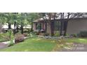 Charming home exterior displaying lush landscaping, mature trees, and a welcoming front yard at 353 Tall Oaks Trl, Fort Mill, SC 29715
