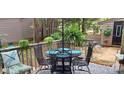 Cozy outdoor patio featuring a dining set, comfortable seating, and a relaxing ambiance amidst natural surroundings at 353 Tall Oaks Trl, Fort Mill, SC 29715