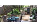 Outdoor patio with dining table and chairs, offering a serene setting surrounded by lush greenery at 353 Tall Oaks Trl, Fort Mill, SC 29715