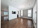 Spacious living room with hardwood floors, stylish lighting, and large windows at 751 Terrace Park, Rock Hill, SC 29730