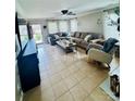 Bright living room featuring a comfortable sectional sofa, tile floors and ample natural light at 7918 Boars Head Ct, Charlotte, NC 28214