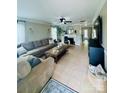 Spacious living room featuring a comfortable sectional sofa, a fireplace, and tile flooring at 7918 Boars Head Ct, Charlotte, NC 28214