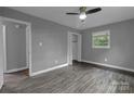 Spacious bedroom with hardwood floors, a ceiling fan, and ample natural light at 102 Central Ave, Bessemer City, NC 28016