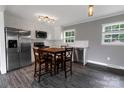 Modern kitchen with stainless steel appliances, white cabinets, and a dining area at 102 Central Ave, Bessemer City, NC 28016
