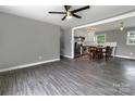 Open-concept living room with hardwood floors and a view into the modern kitchen at 102 Central Ave, Bessemer City, NC 28016