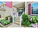 Charming front porch and landscaped garden bed highlight the entry to this beautiful home at 112 E Heart Pine Ln, Statesville, NC 28677