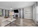 Comfortable living space with a stone accent wall, modern decor, and ample seating at 11834 Planters Estates Dr, Charlotte, NC 28278