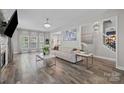 Bright living area with stylish furniture, a decorative fireplace, and plenty of natural light at 11834 Planters Estates Dr, Charlotte, NC 28278