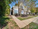 Beautiful townhome featuring meticulously landscaped yard with sidewalk and covered entry way at 120 Prairie View Ct, Belmont, NC 28012