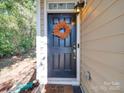 Inviting front door with seasonal wreath, covered porch, and well-maintained exterior at 120 Prairie View Ct, Belmont, NC 28012