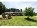 Quaint brick home featuring a large lawn and well maintained landscaping at 1211 25Th Se St, Hickory, NC 28602