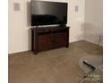 Living room with a dark wood TV stand and contemporary glass side tables at 13116 Erwin Rd, Charlotte, NC 28273