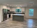 Modern kitchen with stainless steel appliances, a center island, and ample natural light at 138 Zircon Dr, Statesville, NC 28625