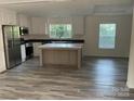 Modern kitchen with stainless steel appliances, a center island, and ample natural light at 138 Zircon Dr, Statesville, NC 28625