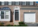 Close-up of a brick facade home showcasing the front door, a bay window, and a one-car garage at 1498 Burrell Nw Ave, Concord, NC 28027
