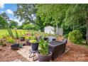 Serene backyard patio featuring outdoor furniture, potted plants, and a charming storage shed at 169 Primrose Ln, Statesville, NC 28625