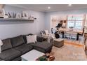Bright living room showcasing a cozy sectional, exercise bike, and a view into the dining area at 1699 Riverdale Dr, Rock Hill, SC 29732