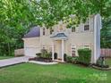 Beautiful two-story home with lush landscaping and a welcoming entrance, showcasing a well-maintained front yard at 216 Devon Forest Dr, Mooresville, NC 28115