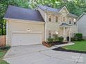 Traditional two-story home with attached garage, featuring a well-kept lawn and inviting front entrance at 216 Devon Forest Dr, Mooresville, NC 28115