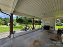 Spacious covered carport featuring ample seating and decorative plants and flowers at 3546 Kershaw Camden Hwy, Lancaster, SC 29720