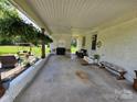 Spacious covered carport featuring ample seating and decorative plants and flowers at 3546 Kershaw Camden Hwy, Lancaster, SC 29720